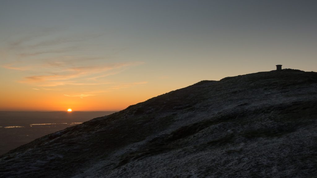 Sun breaks the horizon during sunrise viewed from the Malvern Hills