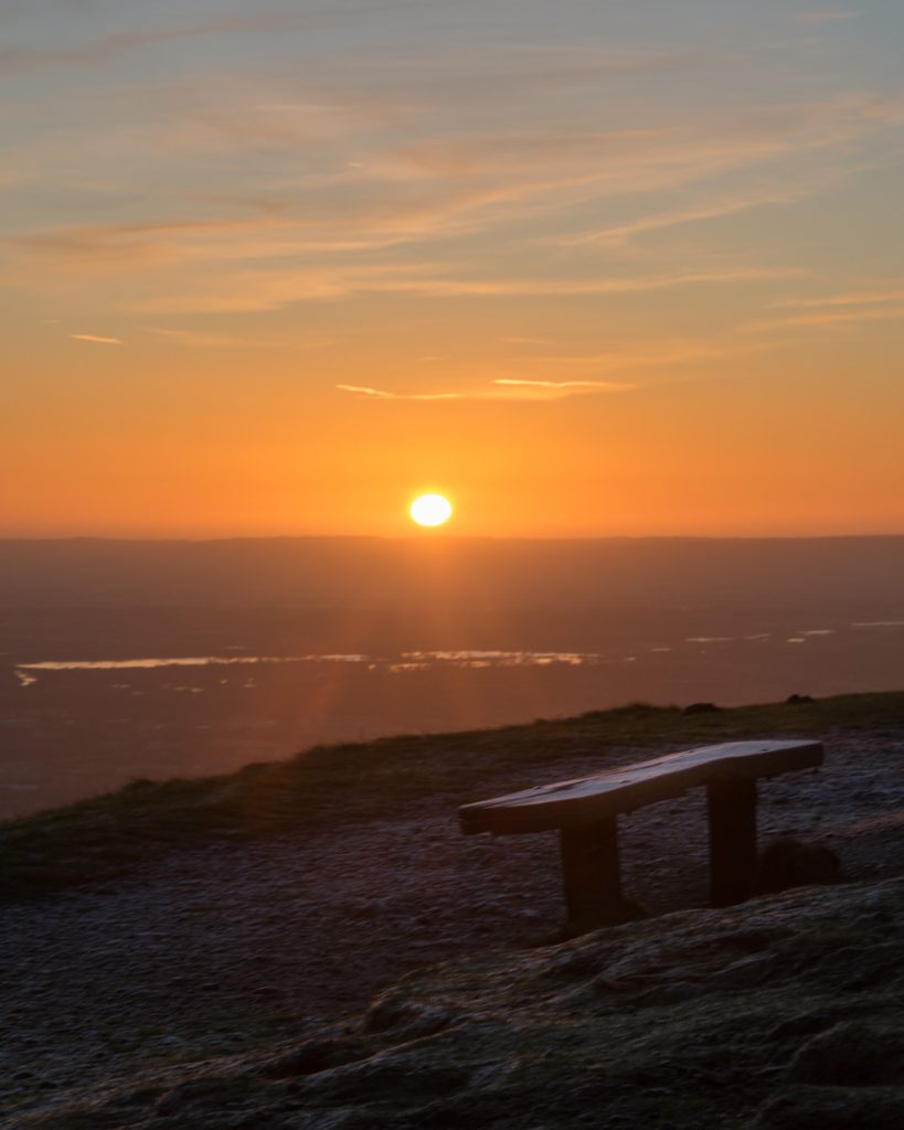 Sun breaks the horizon during sunrise viewed from the Malvern Hills