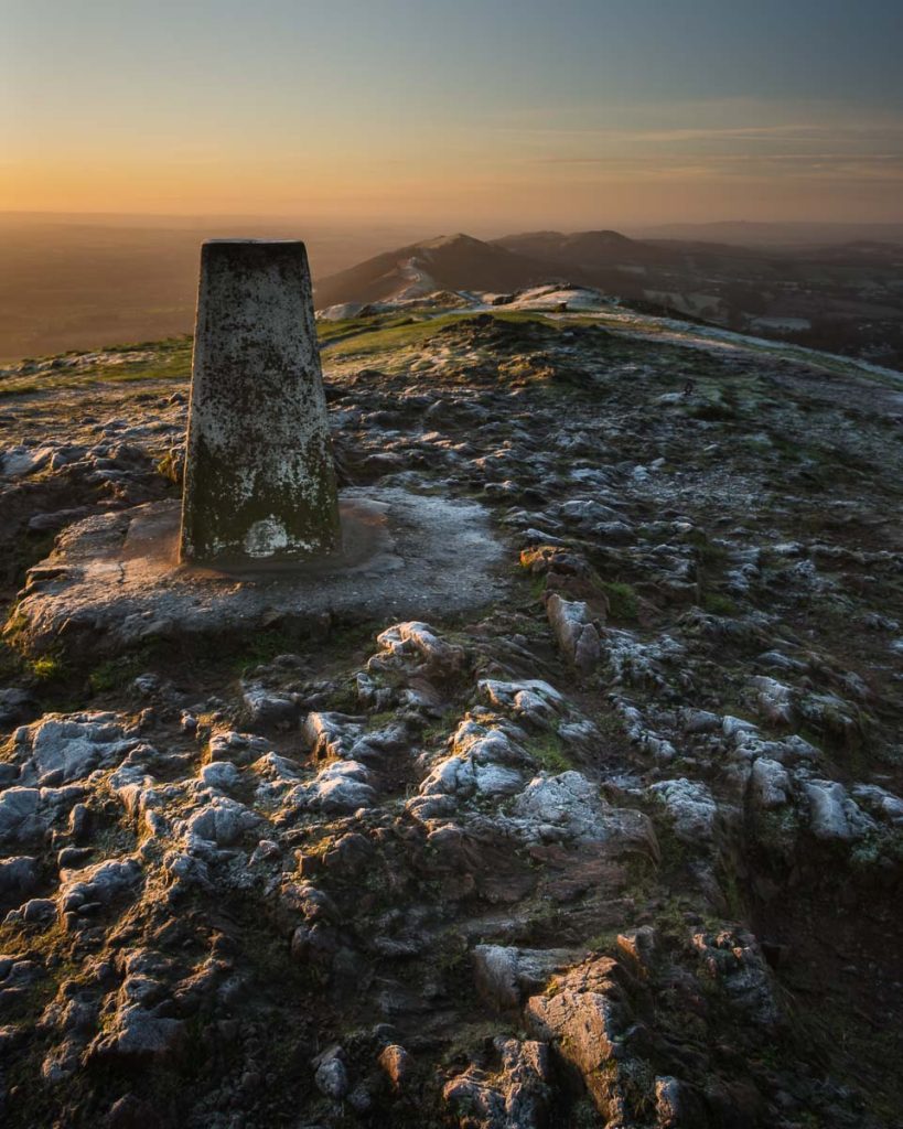 The Worcestershire Beacon trigpoint photographed during sunrise